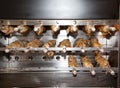 Industrial oven with pieces of meat in the rotisserie baking