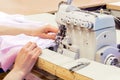 Industrial overlock sewing machine in work