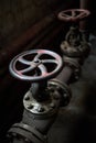 Industrial pair of valves ventil with flanges closeup selective focus over dark industrial steampunk background with