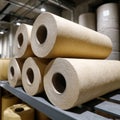 Industrial paper rolls stacked in a warehouse setting. Royalty Free Stock Photo