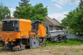 Industrial pavement machine parked on the grass