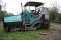 Industrial pavement truck laying fresh asphalt on construction site .