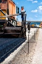 Industrial pavement truck or machine laying fresh bitumen