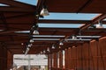 Industrial Pavilion: Wooden Roof Structure with Lamps and Cams