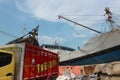 loading commodities from truck into cargo ship