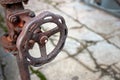 Industrial pipeline and valve close up, blur concrete background. Old rusty control equipment, abandoned plant industry with