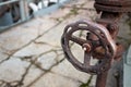 Industrial pipeline and valve close up, blur concrete background. Old rusty control equipment, abandoned plant industry with