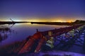 Industrial pipes and ocean harbor landscape at night