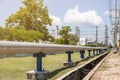 Industrial pipes of steam high pressure beside the road in indus Royalty Free Stock Photo