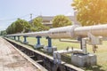 Industrial pipes of steam high pressure beside the road in indus Royalty Free Stock Photo