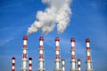 Industrial pipes with white smoke over blue sky. Horizontal photo Royalty Free Stock Photo