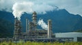 Industrial plant emissions against mountains, showcasing the challenges and solutions of ccus Royalty Free Stock Photo