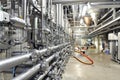 Industrial plant in a modern brewery - technology in a factory building with pipes and fittings Royalty Free Stock Photo