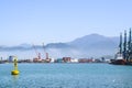 Industrial port blue water clear weather white fog on the backgroundyellow lighthouse landscape