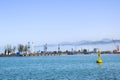 Industrial port blue water clear weather white fog on the backgroundyellow lighthouse landscape