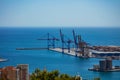 Industrial port cranes in the Malaga bay cargo sea terminal Royalty Free Stock Photo