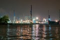 An industrial port with cranes at night with colored lights in Hamburg Royalty Free Stock Photo