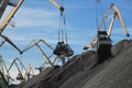 Industrial of portal crane buckets and giant coal heaps