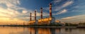 The industrial power plant illuminated by sunset reflections over the water..AI generated image Royalty Free Stock Photo