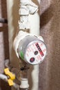 Industrial pressure meter - barometer and water pipes in the background Royalty Free Stock Photo