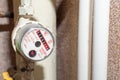 Industrial pressure meter - barometer and water pipes in the background Royalty Free Stock Photo