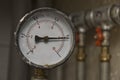 Industrial pressure meter and water pipes Royalty Free Stock Photo