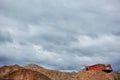 Industrial quarry with mountains of sand, gravel and dump truck