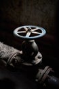 Industrial retro valve or ventil with flanges closeup selective focus over dark industrial steampunk background with