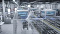 Industrial robot arms placing solar panels on large production line