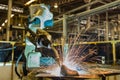 Industrial robot is welding automotive part in factory