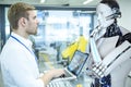 Industrial Robotic Engineer And Humanoid Robot Royalty Free Stock Photo