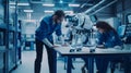 In an industrial robotics factory, colleagues experiment with a prototype robot dog. A computer program is being used
