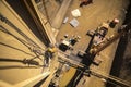 Industrial rope access welder working at heights abseiling with low stretching rope performing wall stretching repairs