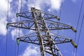 Industrial Scenery: Electric High Voltage Pylon on Blue Sky Back Royalty Free Stock Photo
