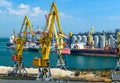 Industrial seaport infrastructure, sea, cranes and dry cargo ship, grain silo, bulk carrier vessel and grain storage elevators, Royalty Free Stock Photo