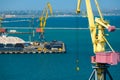 Industrial seaport infrastructure - sea, cranes and minerals, metal and bundles of wire, concept of maritime cargo transportation