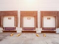 Industrial sectional warehouse gates. In a white warehouse building, there are three automatic garage doors for Royalty Free Stock Photo