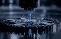 In an industrial setting, a gear component receives precise lubrication under focused lighting with water droplets Royalty Free Stock Photo