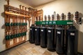 A row of water softener tanks in a room with pipes and valves Royalty Free Stock Photo