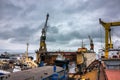 Industrial ship repair yard with floating dock, vessels undergo maintenance. Tugboats assist in marine operations, heavy Royalty Free Stock Photo
