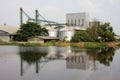 Industrial, silo near pond. Royalty Free Stock Photo