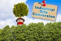 Industrial site conversion and revitalising post-industrial areas concept with a tree on top of a chimney Royalty Free Stock Photo