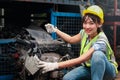 Industrial smiling woman worker wearing helmet repairing with machinery at manufacturing plant factory industry, Asian beautiful Royalty Free Stock Photo