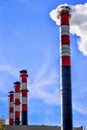 Industrial smoke from chimney on blue sky