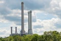 Industrial smokestack over green forest trees Royalty Free Stock Photo