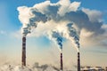 Industrial smokestacks against the blue sky .