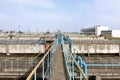 Industrial space with lots of pipes and communications on a background of blue sky. old water treatment plant on the city`s wate Royalty Free Stock Photo