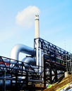 Industrial Steel pipelines smokestack blue sky Royalty Free Stock Photo