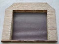 Industrial Storefront Appearance, Textured Metallic Shutter Combined With Rustic Brick Archway Royalty Free Stock Photo