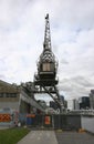 Historic wharf crane, warehouse and coastal cityscape of skyscrapers on Yarra River, Docklands, Melbourne, Victoria, Australia
